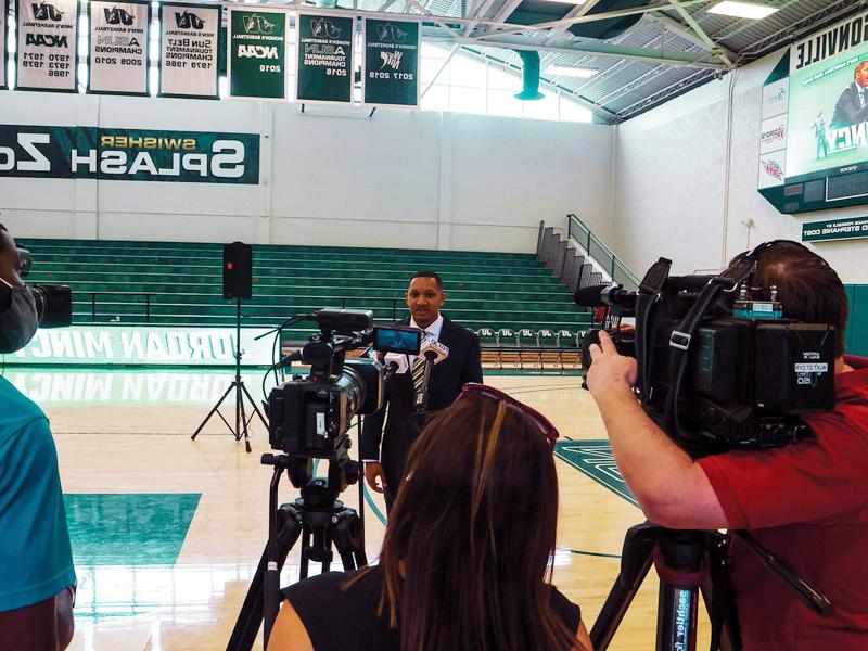 JU Sport Business student being interviewed in the JU gymnasium.